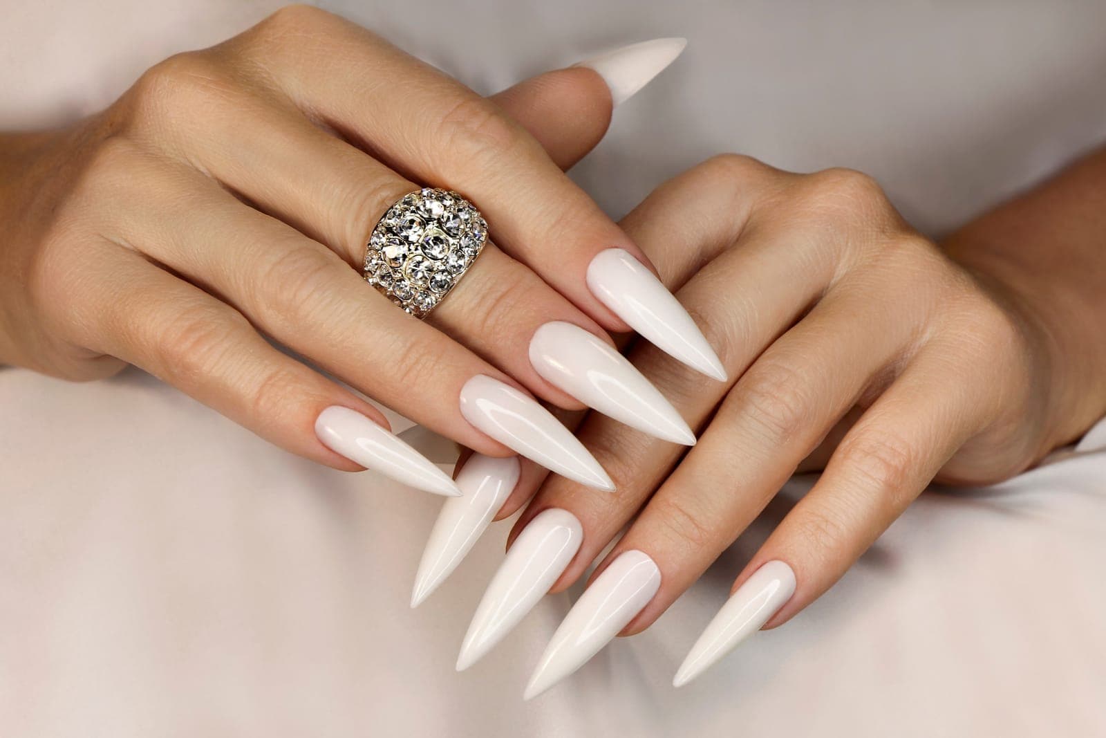 Long white stiletto nail extensions with jewelry — Mani Magic Studio, Richmond Hill