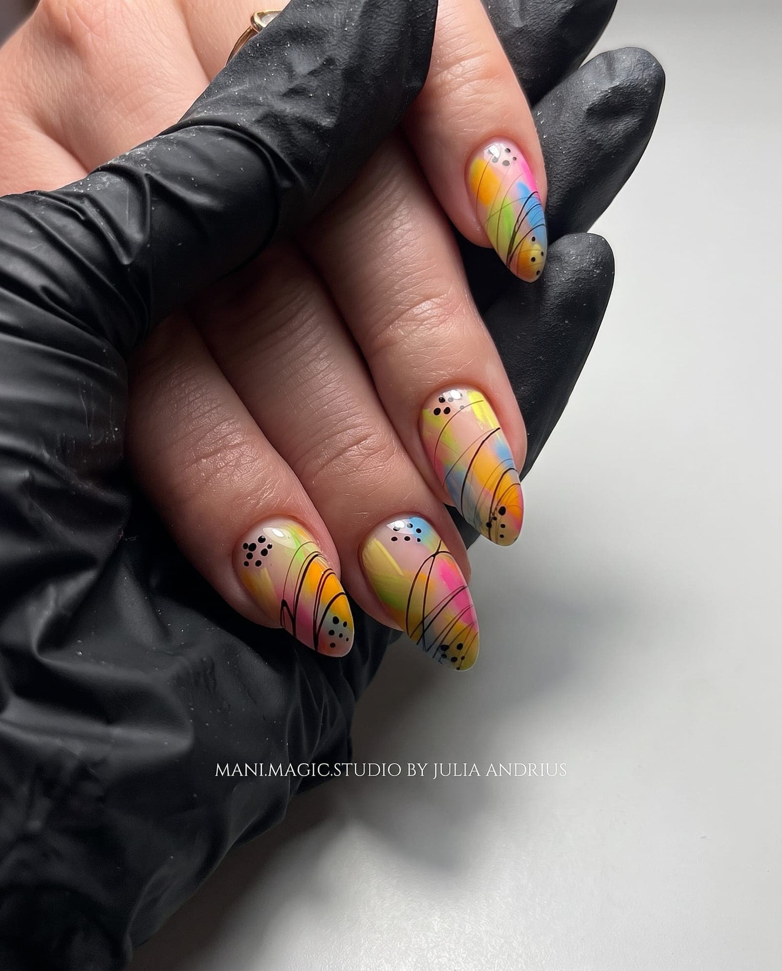 Abstract hand-painted nail art in warm tones